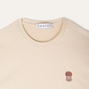 Close-up of the dark brown jellyfish motif on the KAMPOS light sand T-shirt