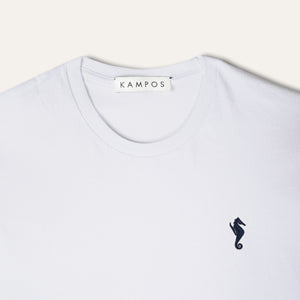 Close-up of the navy seahorse motif on the KAMPOS white T-shirt